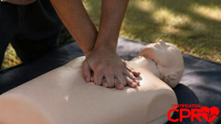 Person performing hands-only CPR on a mannequin outdoors in Las Vegas.
